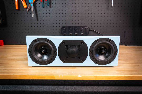 Light blue Illuminate 4c centre speaker with two woofers and a central tweeter