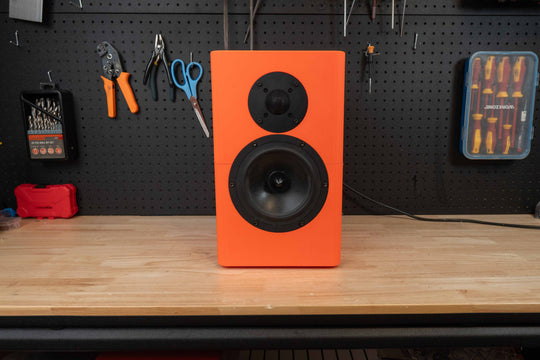 Orange Illuminate 7 Mk2 bookshelf speaker with its woofer and tweeter